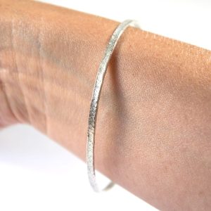 Recycled Silver Textured Kalimera Bangle on wrist by Lisa Rothwell-Young