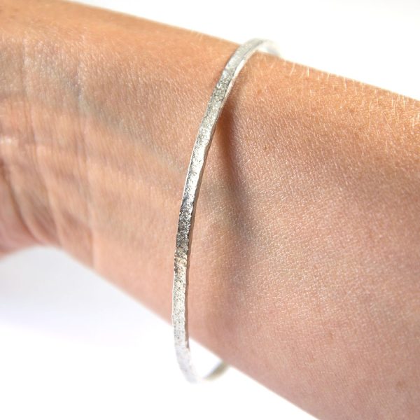 Recycled Silver Textured Kalimera Bangle on wrist by Lisa Rothwell-Young