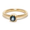 A Minimalist Engagement Ring in yellow gold set with a sapphire or conflict free diamond