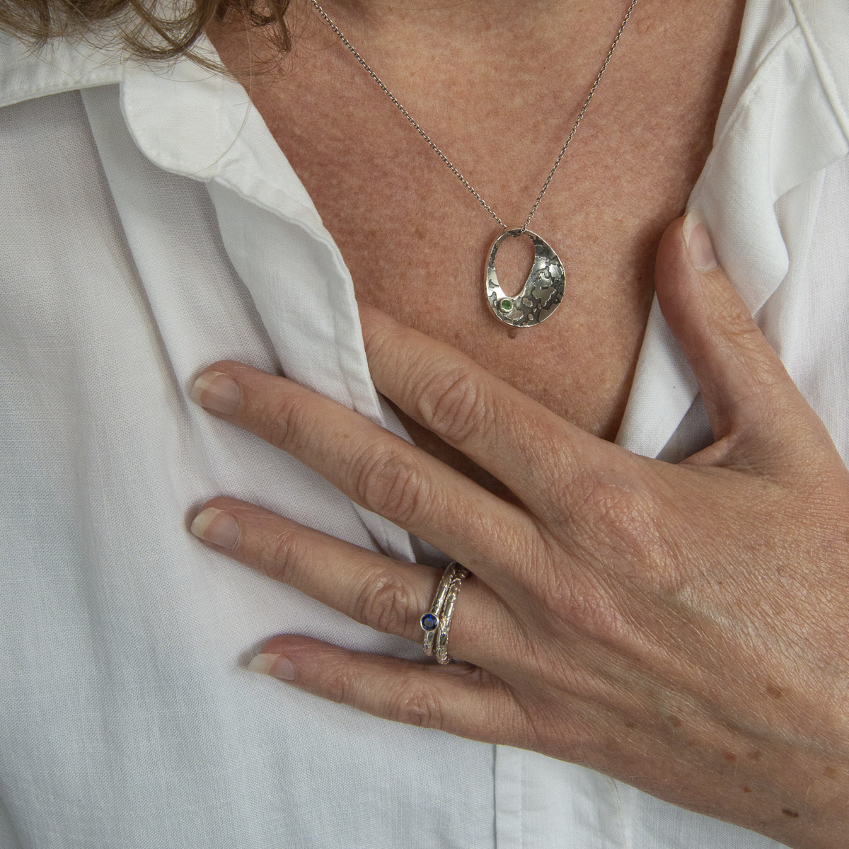 Ethical and sustainable silver and emerald lichen pendant worn | Lisa Rothwell-Young