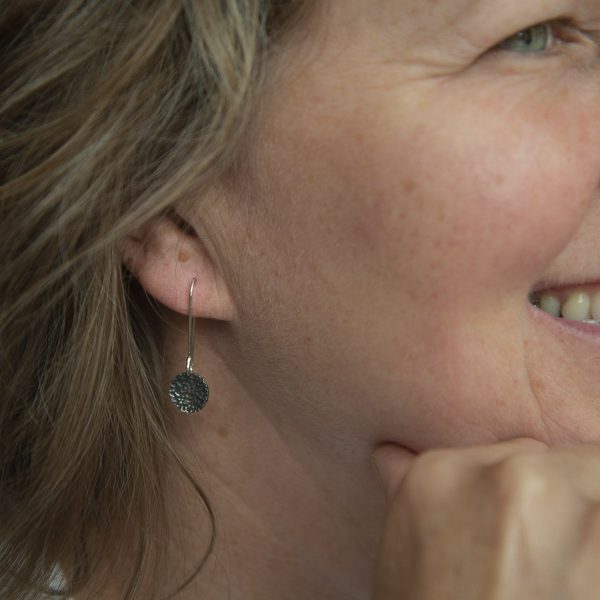 Recycled silver oxidised lichen textured drop earrings worn