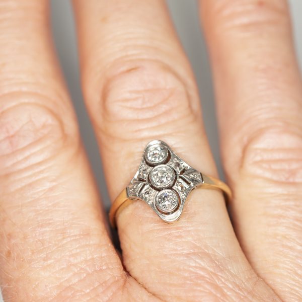 Navette shaped white and yellow gold cluster ring worn