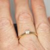 A yellow gold and diamond vintage solitaire ring worn