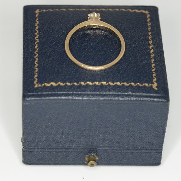 A yellow gold and diamond vintage solitaire ring rear view