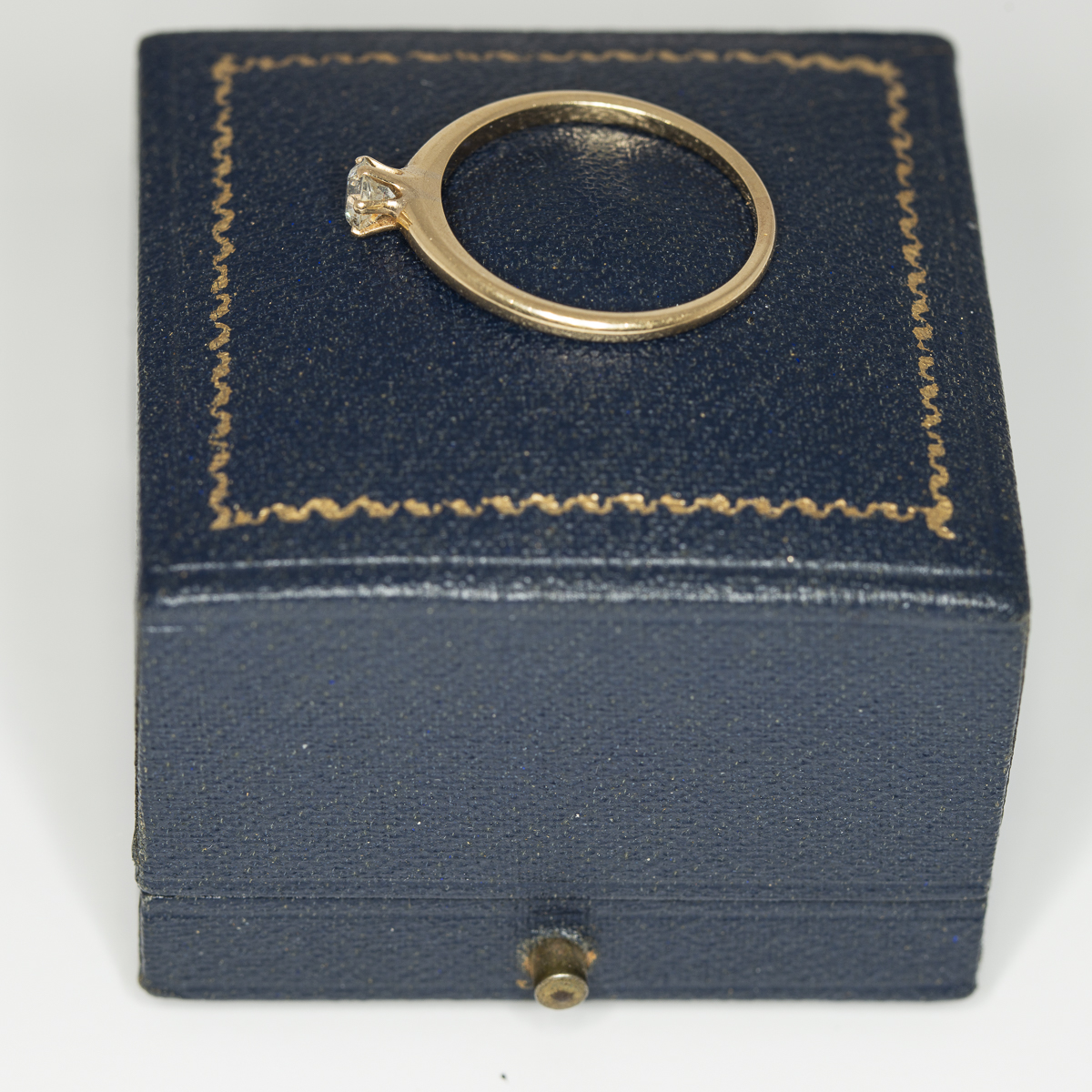 A yellow gold and diamond vintage solitaire ring side view